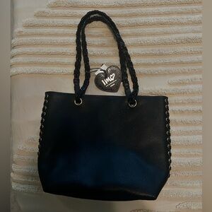 Black faux leather purse with red interior